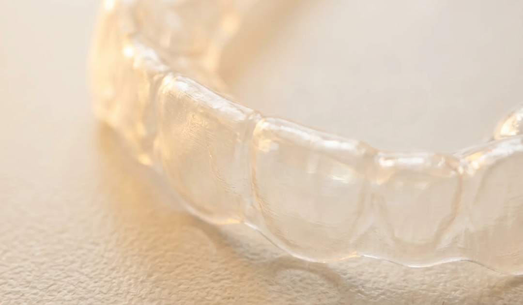 clear retainer tray in warm setting up close jawology