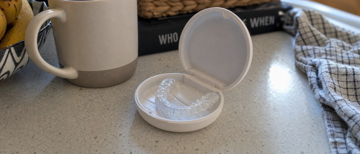 A cracked night guard resting on a kitchen counter