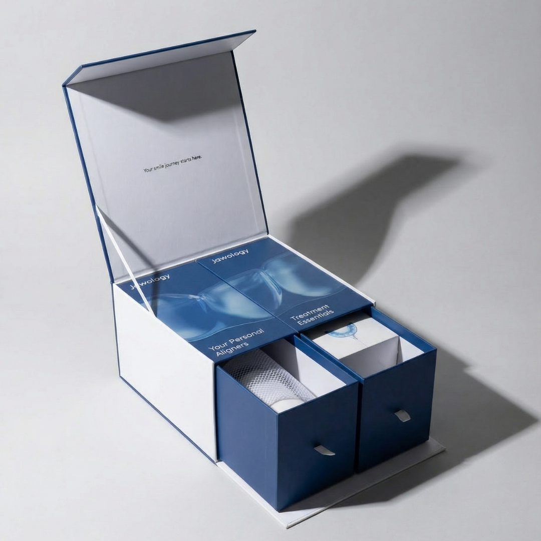 Blue and white jawology treatment box showing contents inside on a light gray background