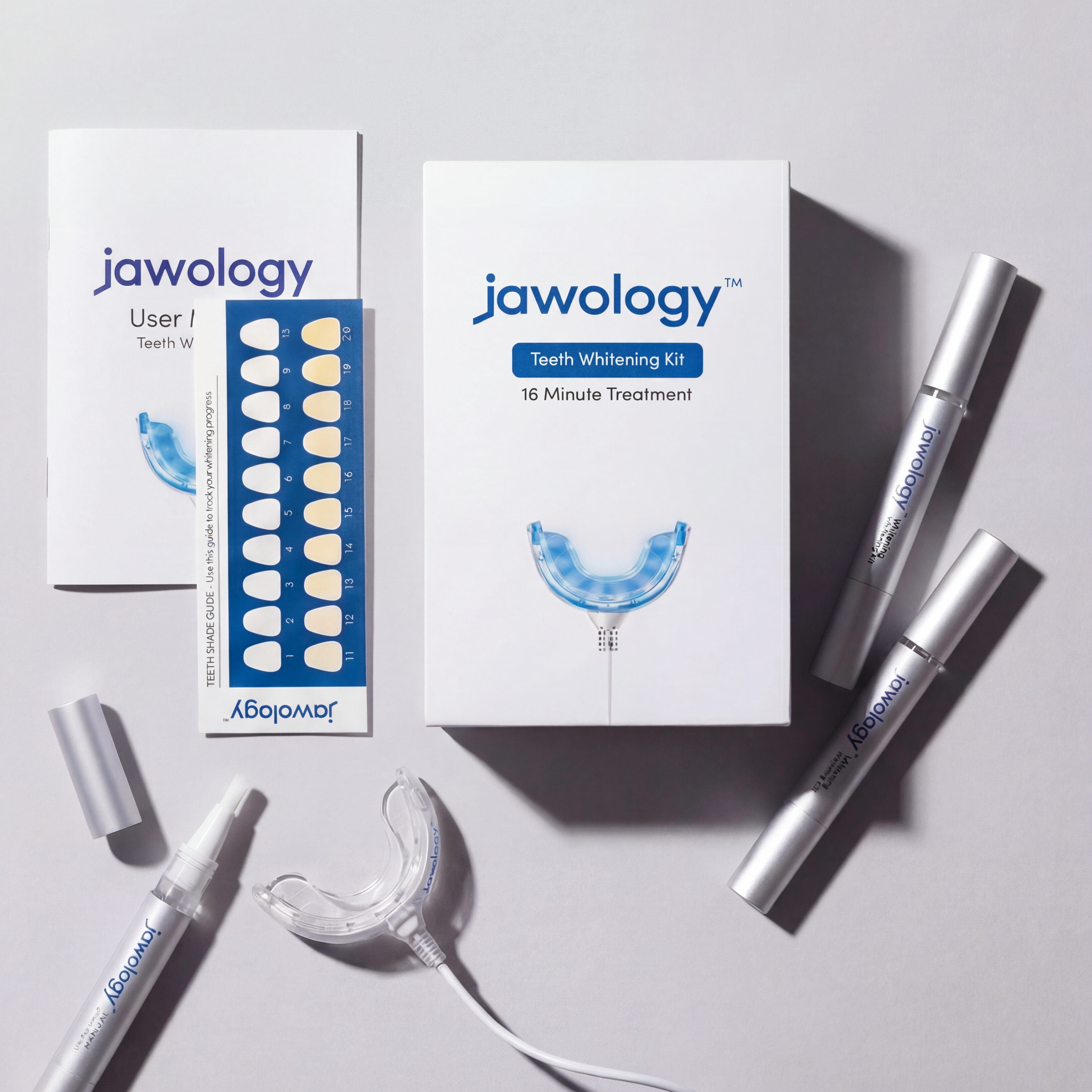 Jawology teeth whitening kit with packaging and components on a light gray background